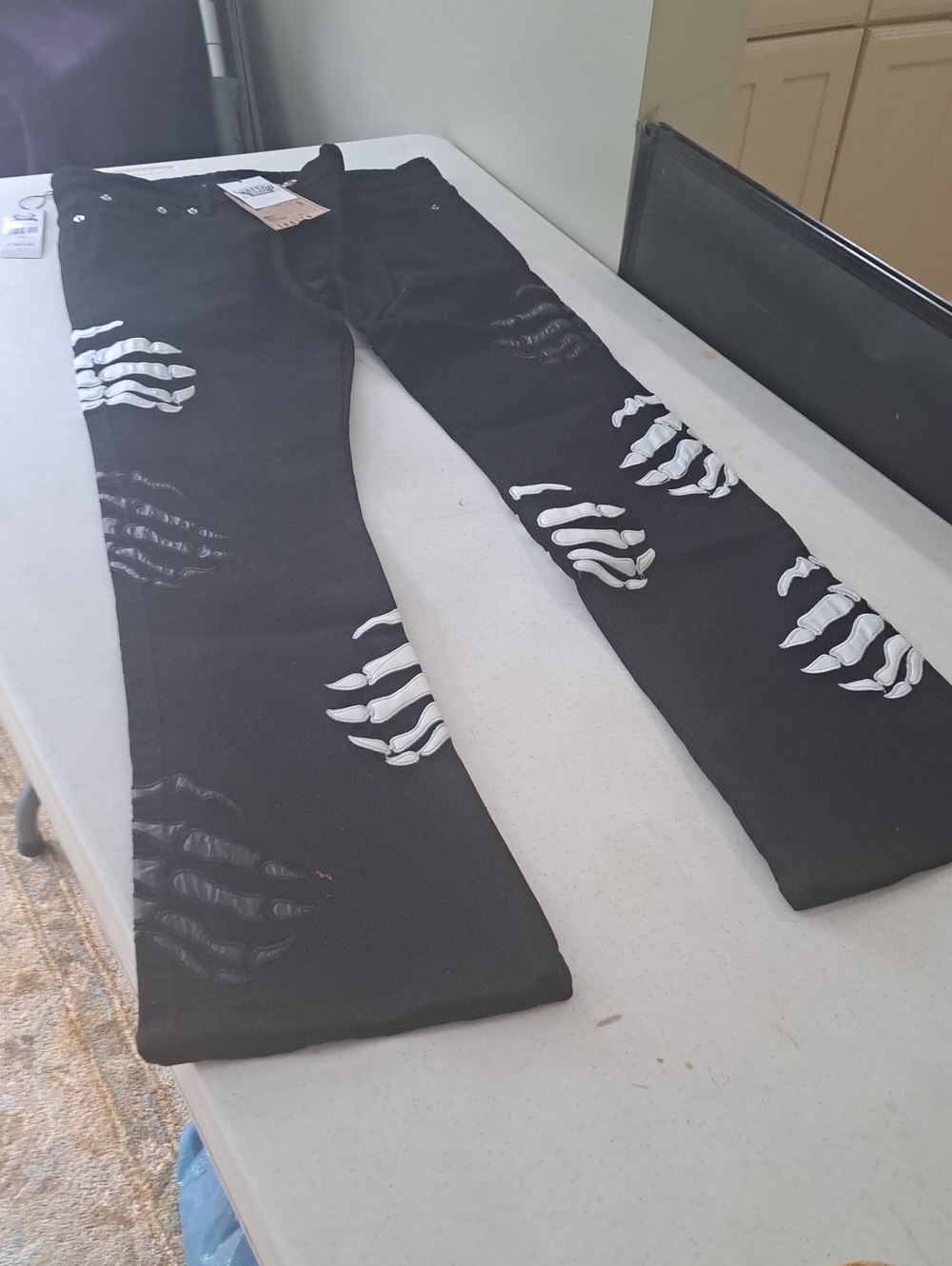 Black men's Ripped Skeleton-Print Jeans
